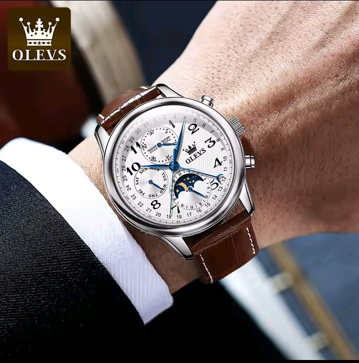 OLEVS leather strap watch worn with a suit